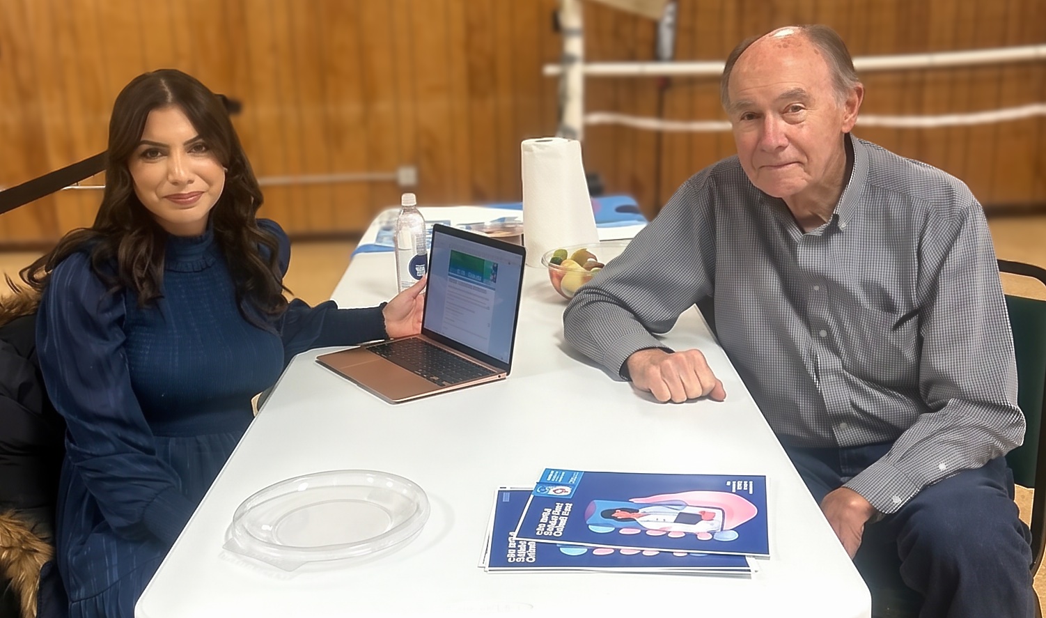 DRHC Fellow Jasrina Kaushal sitting at a table with an elderly community member during an Ohio deployment.